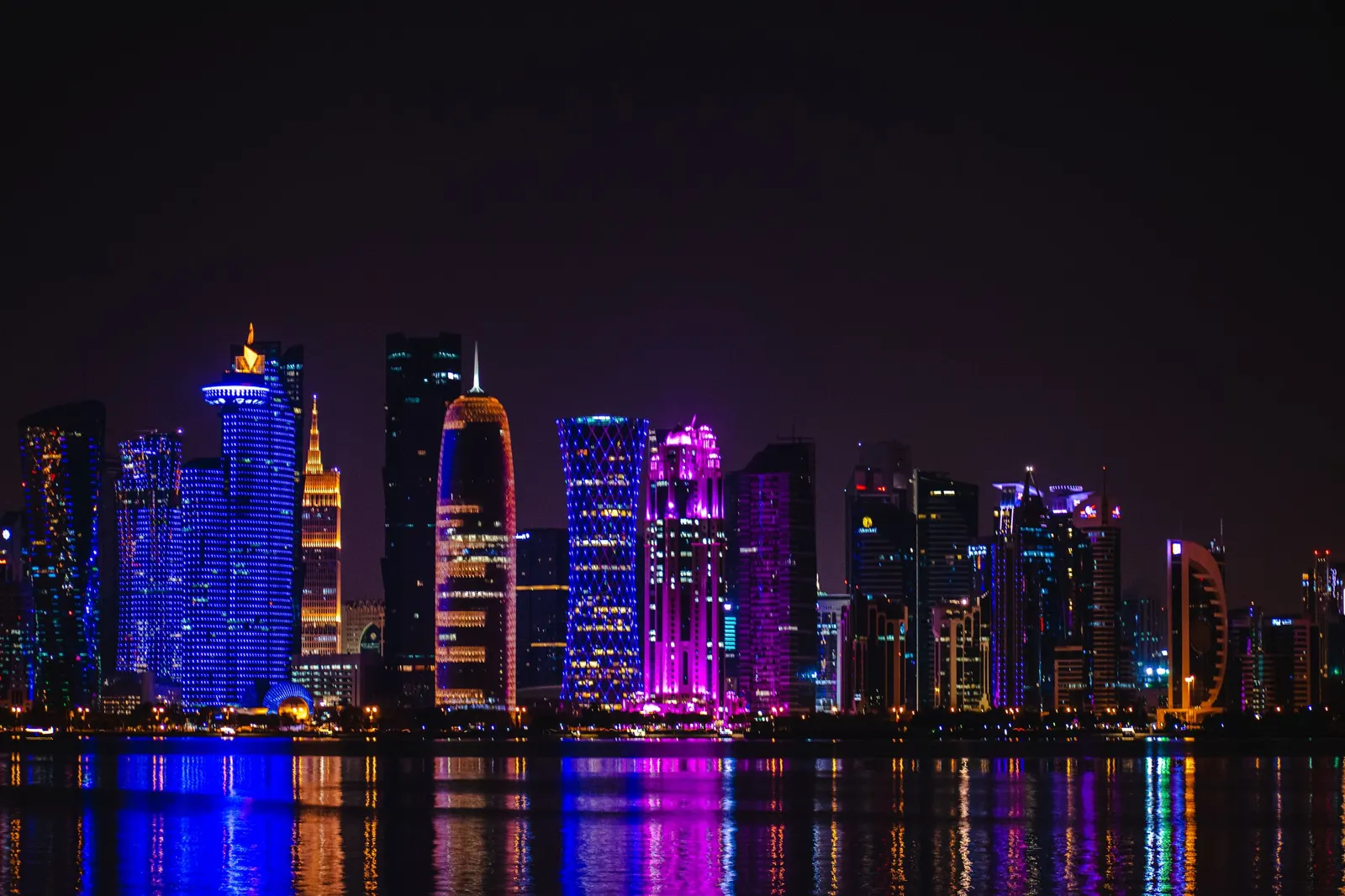 The Doha skyline at night, lit across the water